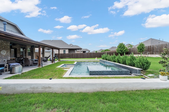 view of swimming pool with a yard, a patio, an in ground hot tub, and a fenced backyard