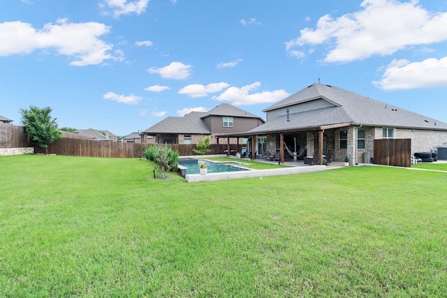 back of property featuring a lawn, a fenced backyard, a fenced in pool, and a patio