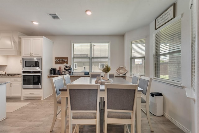 dining area featuring plenty of natural light, light wood finished floors, recessed lighting, and visible vents
