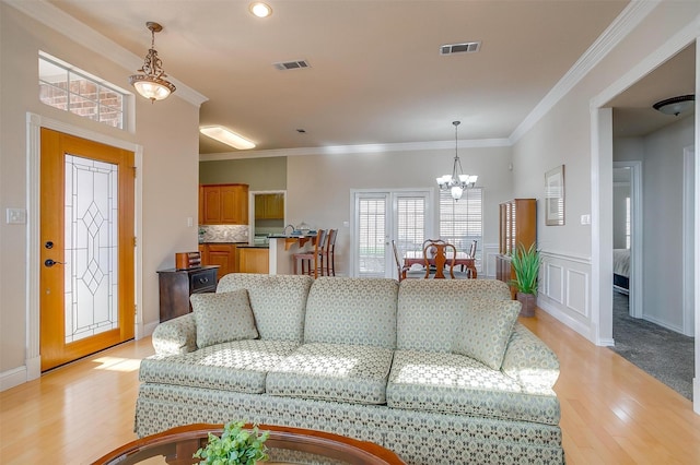 11632 Virginia Way Ct, Fort Worth, TX 76008 - living room featuring ornamental molding, a notable chandelier, visible vents, and light wood-style flooring