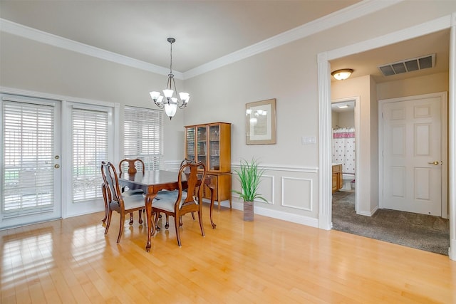 11632 Virginia Way Ct, Fort Worth, TX 76008 - dining space with a chandelier, light wood-type flooring, visible vents, and crown molding