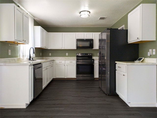 920 Kendall Dr, Arlington, TX 76001 - kitchen with electric range, black microwave, a sink, stainless steel dishwasher, and white cabinets