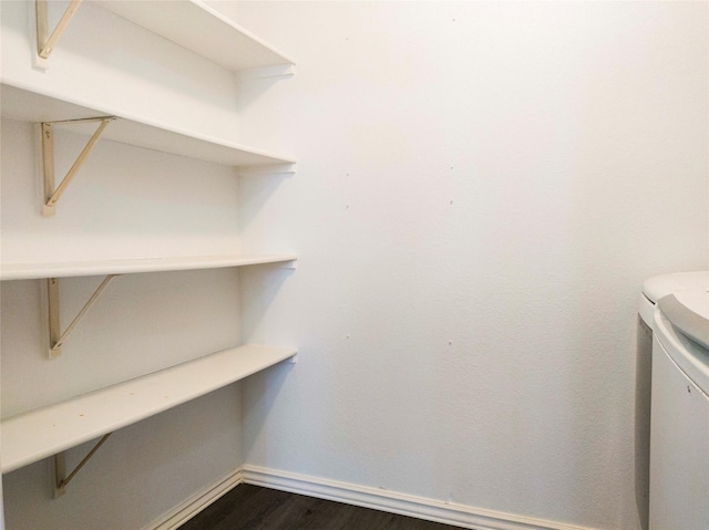 920 Kendall Dr, Arlington, TX 76001 - laundry area with baseboards, dark wood-type flooring, and washing machine and clothes dryer