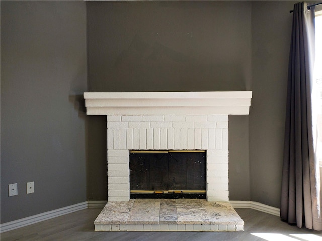 920 Kendall Dr, Arlington, TX 76001 - detailed view of a fireplace, wood finished floors, and baseboards