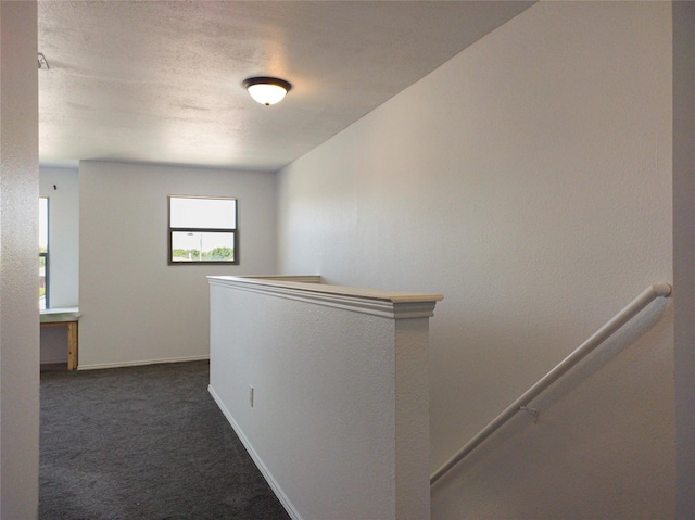 920 Kendall Dr, Arlington, TX 76001 - hallway featuring an upstairs landing, dark carpet, and baseboards