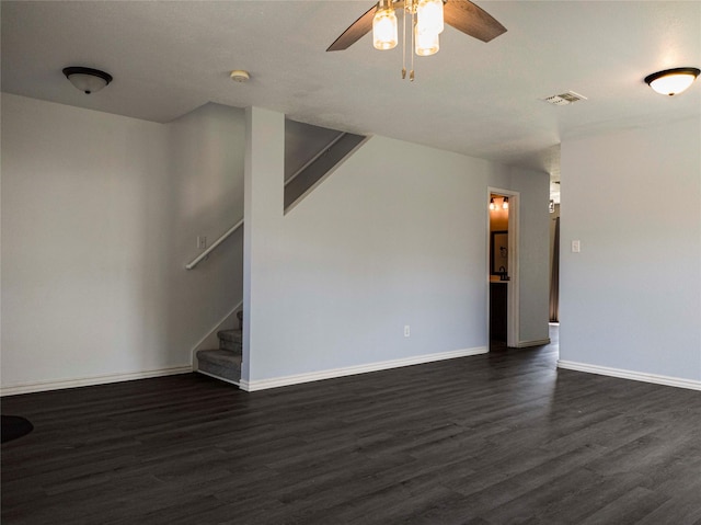 920 Kendall Dr, Arlington, TX 76001 - unfurnished living room featuring dark wood-style flooring, ceiling fan, baseboards, and stairs
