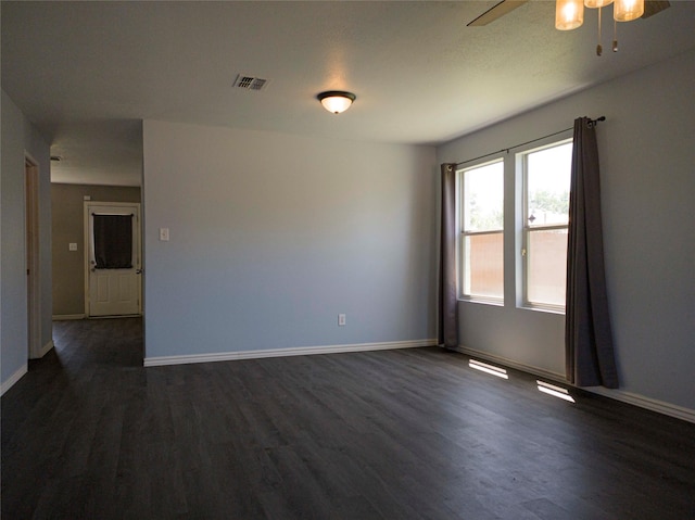 920 Kendall Dr, Arlington, TX 76001 - spare room with dark wood-style floors, ceiling fan, and baseboards