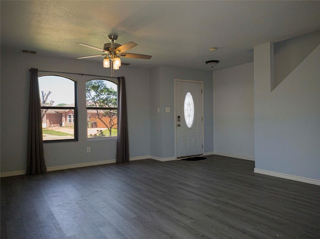920 Kendall Dr, Arlington, TX 76001 - entrance foyer with dark wood-type flooring, ceiling fan, and baseboards