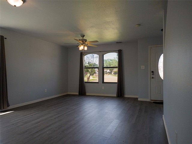 920 Kendall Dr, Arlington, TX 76001 - unfurnished room with dark wood finished floors, ceiling fan, baseboards, a textured ceiling, and a smoke detector