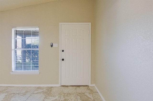 interior space featuring baseboards and light tile patterned floors