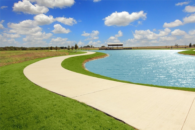 view of property's community featuring a yard and a water view