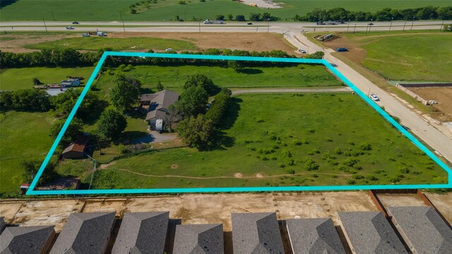 birds eye view of property with a rural view