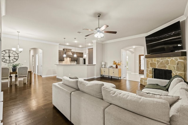 7401 Green Mesa Rd, Ponder, TX 76259 - living area featuring arched walkways, ceiling fan, dark wood-style floors, a fireplace, and crown molding