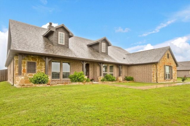 7401 Green Mesa Rd, Ponder, TX 76259 - new england style home featuring stone siding, roof with shingles, a front lawn, and a chimney