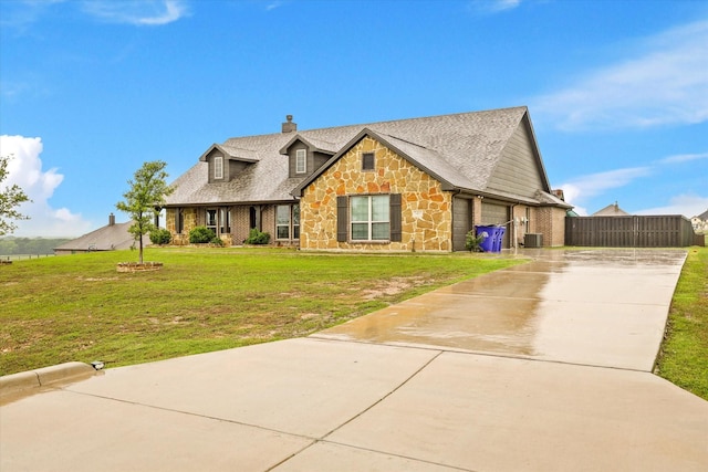 7401 Green Mesa Rd, Ponder, TX 76259 - view of front of home featuring stone siding, driveway, a chimney, central air condition unit, and a garage