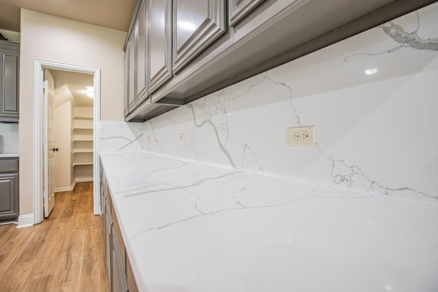 interior space with decorative backsplash and wood finished floors