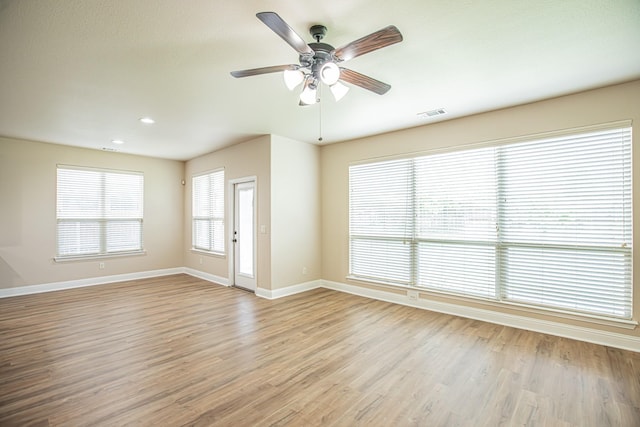 empty room with visible vents, baseboards, ceiling fan, recessed lighting, and light wood-type flooring
