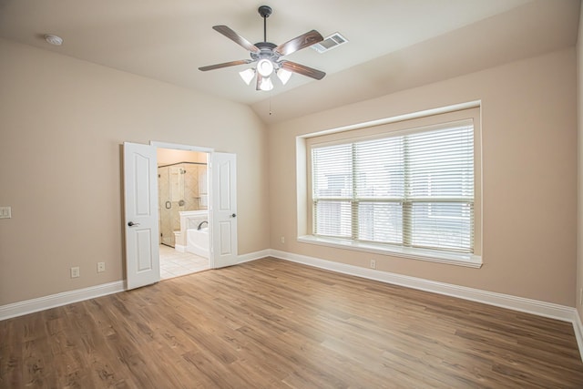 empty room featuring visible vents, a ceiling fan, baseboards, and wood finished floors
