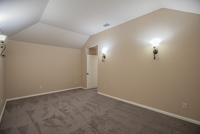 additional living space featuring baseboards, visible vents, carpet flooring, and lofted ceiling