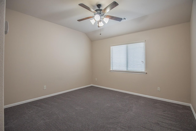empty room featuring dark colored carpet, baseboards, ceiling fan, and vaulted ceiling