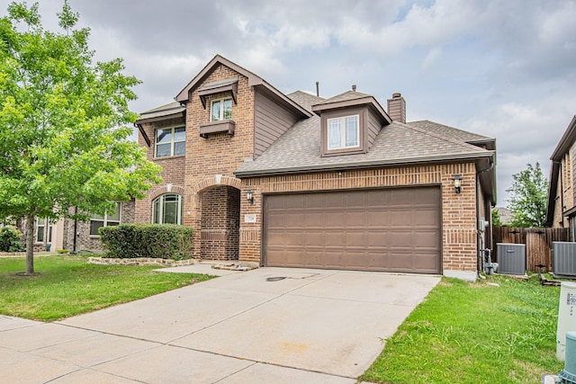 view of front facade with a shingled roof, brick siding, a chimney, cooling unit, and driveway
