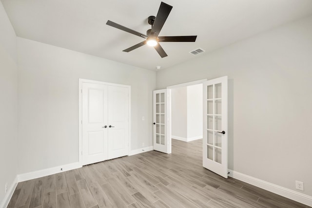 2708 Creekhollow Ct, Denton, TX 76226 - unfurnished bedroom featuring french doors, wood finished floors, a closet, and a ceiling fan