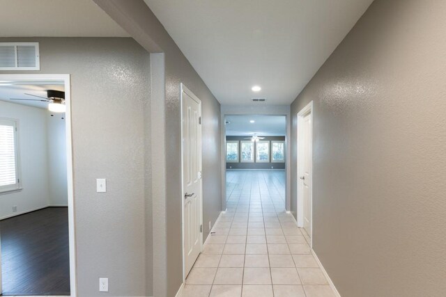 15905 Avenel Way, Fort Worth, TX 76177 - hall featuring light tile patterned floors, a textured wall, and baseboards
