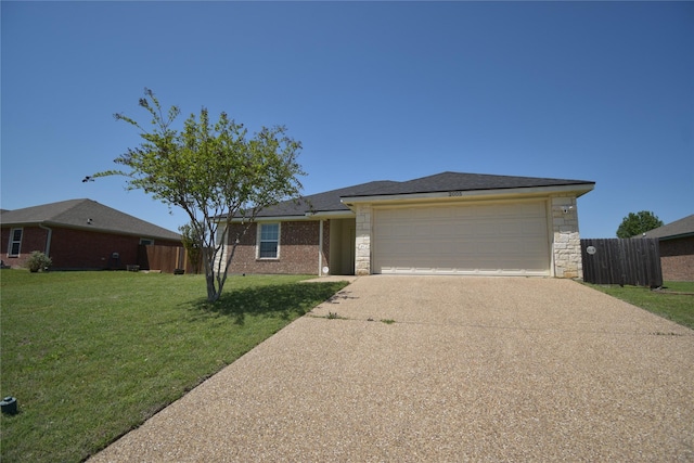 view of front of property featuring fence, a front lawn, concrete driveway, stone siding, and a garage