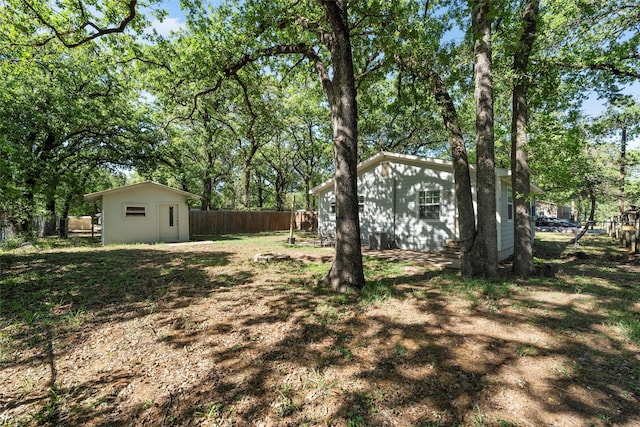 111 Peaceful Ln, Lacy Lakeview, TX 76705 - view of yard featuring an outdoor structure, a shed, and a fenced backyard