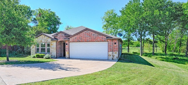 351 Peachtree Ln, Princeton, TX 75407 - ranch-style home with a front lawn, stone siding, brick siding, concrete driveway, and an attached garage