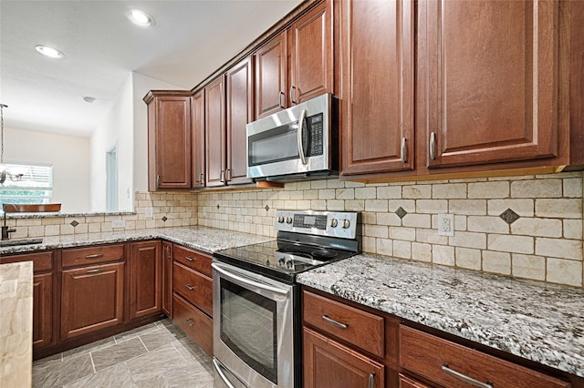 351 Peachtree Ln, Princeton, TX 75407 - kitchen featuring recessed lighting, light stone countertops, appliances with stainless steel finishes, and decorative backsplash