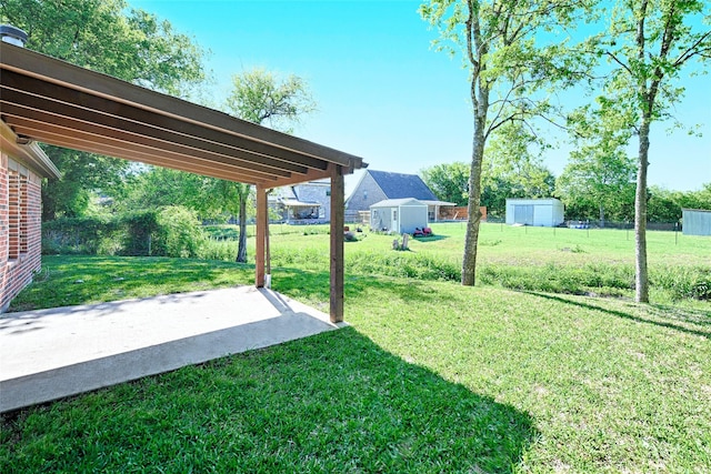 351 Peachtree Ln, Princeton, TX 75407 - view of yard featuring a patio, a storage unit, fence, and an outbuilding