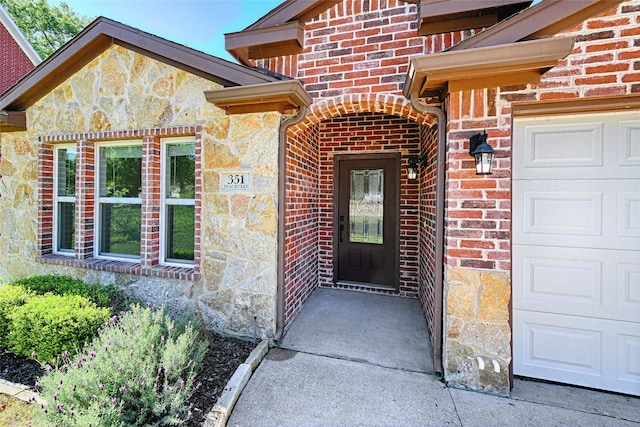 351 Peachtree Ln, Princeton, TX 75407 - property entrance with brick siding, an attached garage, and stone siding