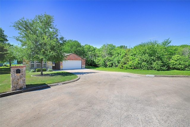 351 Peachtree Ln, Princeton, TX 75407 - view of front of property featuring concrete driveway, brick siding, a front lawn, and a garage