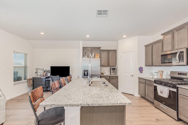 1607 Grand Villa St, Princeton, TX 75407 - kitchen featuring light wood finished floors, stainless steel appliances, visible vents, and a sink