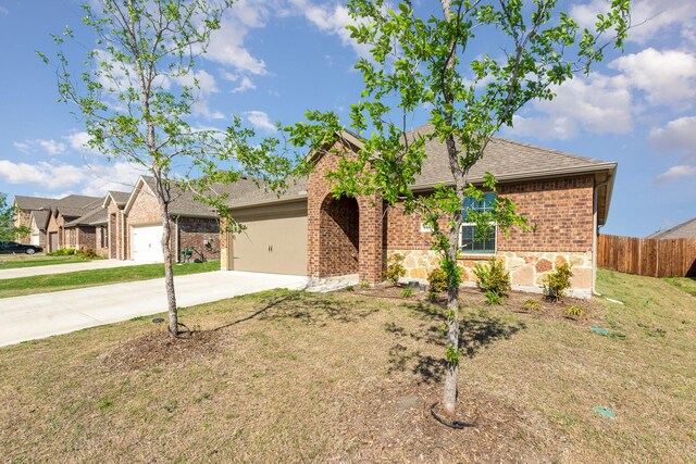 1607 Grand Villa St, Princeton, TX 75407 - single story home featuring driveway, fence, a garage, brick siding, and roof with shingles