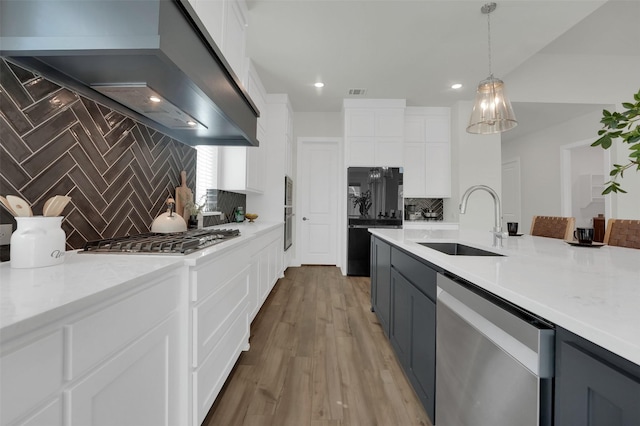4330 Silver Spur Dr, Prosper, TX 75078 - kitchen featuring stainless steel appliances, a sink, extractor fan, decorative backsplash, and white cabinets