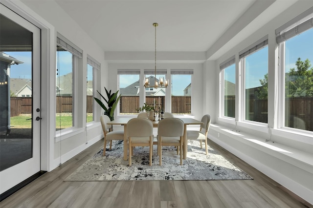 4330 Silver Spur Dr, Prosper, TX 75078 - sunroom with a chandelier, healthy amount of natural light, wood finished floors, and baseboards