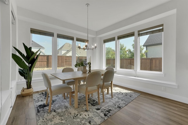 4330 Silver Spur Dr, Prosper, TX 75078 - dining space featuring healthy amount of natural light, a chandelier, and wood finished floors