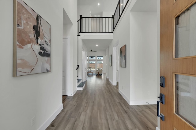 4330 Silver Spur Dr, Prosper, TX 75078 - hallway with wood finished floors, baseboards, and a towering ceiling