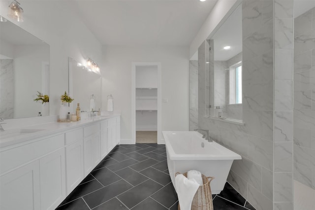 4330 Silver Spur Dr, Prosper, TX 75078 - full bathroom with a freestanding bath, double vanity, a spacious closet, and tile patterned floors