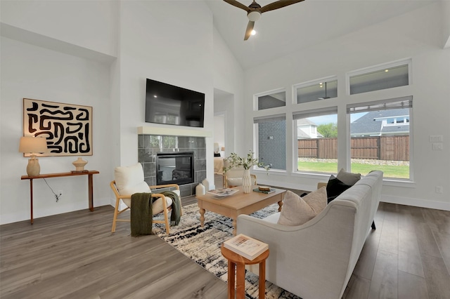 4330 Silver Spur Dr, Prosper, TX 75078 - living room with a tile fireplace, wood finished floors, ceiling fan, high vaulted ceiling, and baseboards