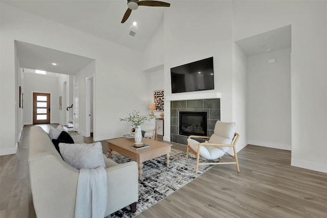 4330 Silver Spur Dr, Prosper, TX 75078 - living area with wood finished floors, baseboards, a fireplace, ceiling fan, and high vaulted ceiling