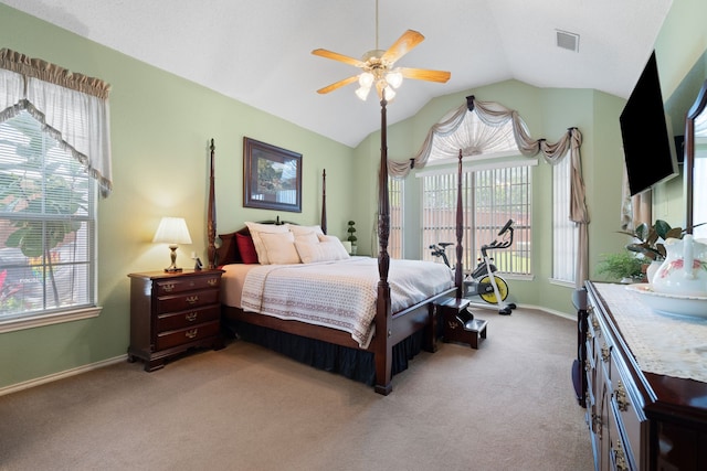 bedroom with lofted ceiling, light carpet, visible vents, and multiple windows