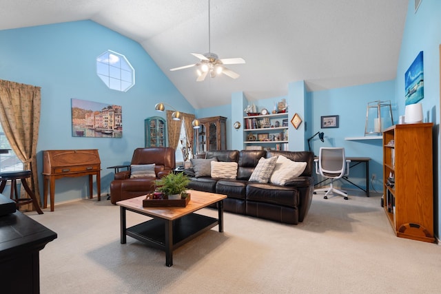 living area with light colored carpet, ceiling fan, and high vaulted ceiling