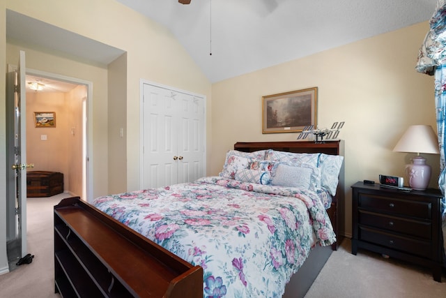 bedroom featuring light colored carpet, ceiling fan, lofted ceiling, and a closet