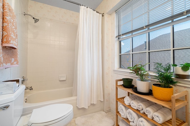bathroom with shower / tub combo and toilet