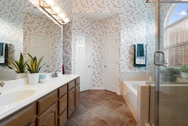 bathroom with a sink, wallpapered walls, and a stall shower