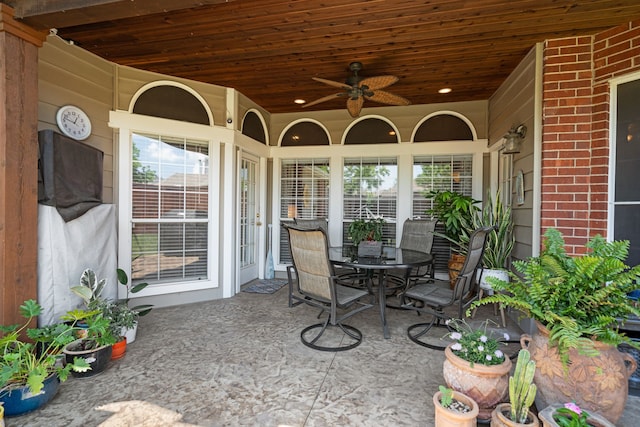 view of patio with outdoor dining area and ceiling fan