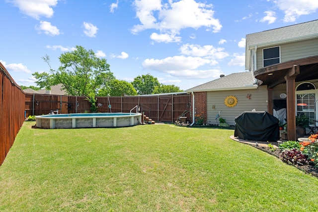 view of yard with a fenced in pool and a fenced backyard
